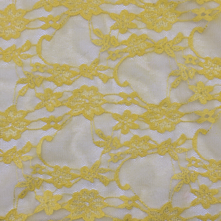 Close-up of yellow lace fabric with intricate patterns